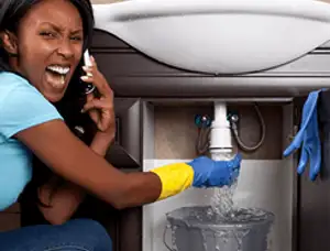 Emergency plumbing repair for a leaking sink drain under a bathroom vanity in Fort Lauderdale, FL