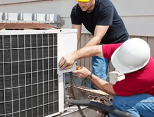 HVAC technicians repairing an outdoor AC unit on a rooftop in Fort Lauderdale, FL